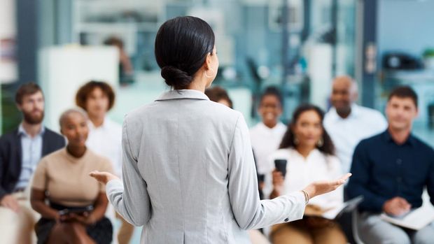 Rearview shot of an unrecognizable businesswoman giving a presentation in the office boardroom