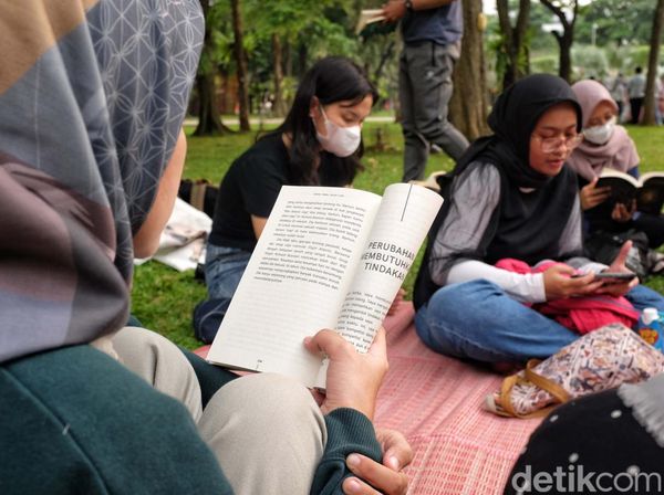 Asyiknya Baca Buku di Bawah Pohon Rindang Taman Kota