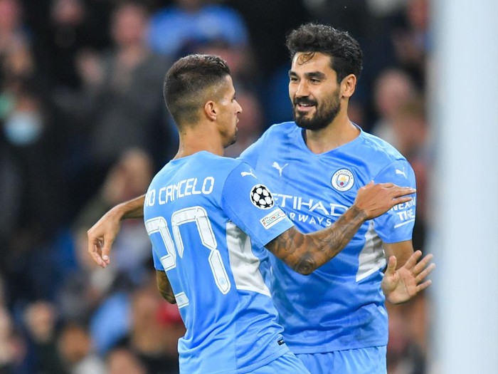 MANCHESTER, ENGLAND - SEPTEMBER 15: Manchester Citys Joao Cancelo celebrates scoring his sides fifth goal with Ilkay Gundogan during the UEFA Champions League group A match between Manchester City and RB Leipzig at Etihad Stadium on September 15, 2021 in Manchester, United Kingdom. (Photo by Dave Howarth - CameraSport via Getty Images)