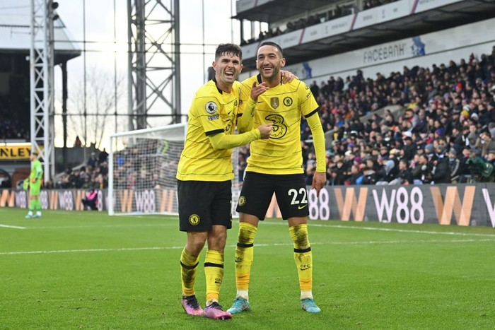 Chelseas Moroccan midfielder Hakim Ziyech (R) celebrates with Chelseas US midfielder Christian Pulisic (L) after scoring a goal during the English Premier League football match between Crystal Palace and Chelsea at Selhurst Park in south London on February 19, 2022. - RESTRICTED TO EDITORIAL USE. No use with unauthorized audio, video, data, fixture lists, club/league logos or live services. Online in-match use limited to 120 images. An additional 40 images may be used in extra time. No video emulation. Social media in-match use limited to 120 images. An additional 40 images may be used in extra time. No use in betting publications, games or single club/league/player publications. (Photo by Glyn KIRK / AFP) / RESTRICTED TO EDITORIAL USE. No use with unauthorized audio, video, data, fixture lists, club/league logos or live services. Online in-match use limited to 120 images. An additional 40 images may be used in extra time. No video emulation. Social media in-match use limited to 120 images. An additional 40 images may be used in extra time. No use in betting publications, games or single club/league/player publications. / RESTRICTED TO EDITORIAL USE. No use with unauthorized audio, video, data, fixture lists, club/league logos or live services. Online in-match use limited to 120 images. An additional 40 images may be used in extra time. No video emulation. Social media in-match use limited to 120 images. An additional 40 images may be used in extra time. No use in betting publications, games or single club/league/player publications. (Photo by GLYN KIRK/AFP via Getty Images)