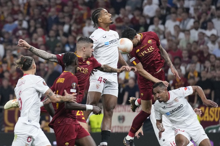 Sevillas Loic Bade, top, heads the ball during the Europa League final soccer match between Roma and Sevilla at the Puskas Arena stadium in Budapest, Hungary, Wednesday, May 31, 2023. (AP Photo/Darko Bandic)