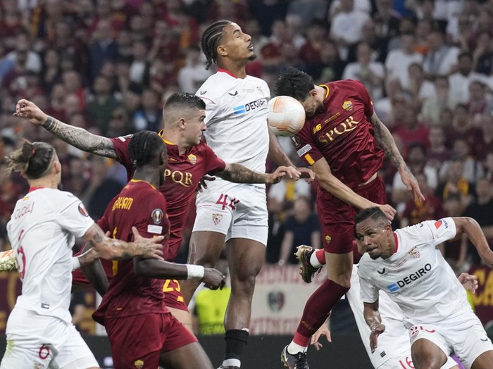 Sevilla's Loic Bade, top, heads the ball during the Europa League final soccer match between Roma and Sevilla at the Puskas Arena stadium in Budapest, Hungary, Wednesday, May 31, 2023. (AP Photo/Darko Bandic)