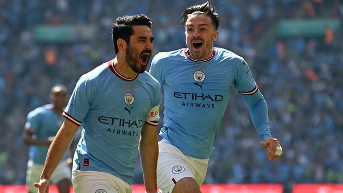 Manchester Citys German midfielder Ilkay Gundogan celebrates with Manchester Citys English midfielder Jack Grealish (R) after scoring the early opening goal during the English FA Cup final football match between Manchester City and Manchester United at Wembley stadium, in London, on June 3, 2023. (Photo by Glyn KIRK / AFP) / NOT FOR MARKETING OR ADVERTISING USE / RESTRICTED TO EDITORIAL USE (Photo by GLYN KIRK/AFP via Getty Images)
