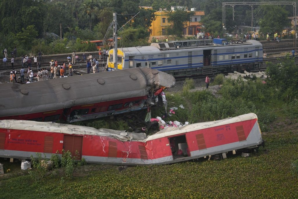 Policemen stand guard at the site where trains that derailed, in Balasore district, in the eastern Indian state of Orissa, Sunday, June 4, 2023. Indian authorities end rescue work and begin clearing mangled wreckage of two passenger trains that derailed in eastern India, killing over 300 people and injuring hundreds in one of the country’s deadliest rail crashes in decades. (AP Photo/Rafiq Maqbool)