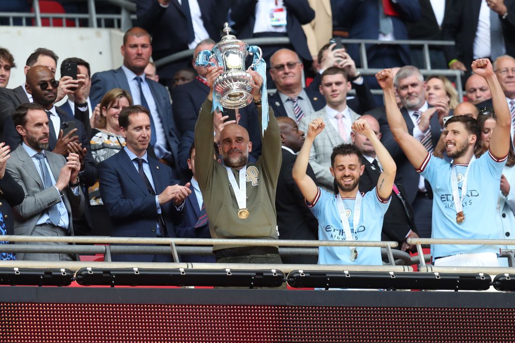 LONDON, ENGLAND - JUNE 3: Manchester City manager Pep Guardiola celebrates with the FA Cup during the Emirates FA Cup Final between Manchester City and Manchester United at Wembley Stadium on June 3, 2023 in London, England. (Photo by Mark Leech/Offside/Offside via Getty Images)