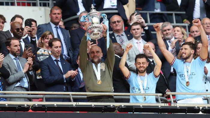 LONDON, ENGLAND - JUNE 3: Manchester City manager Pep Guardiola celebrates with the FA Cup during the Emirates FA Cup Final between Manchester City and Manchester United at Wembley Stadium on June 3, 2023 in London, England. (Photo by Mark Leech/Offside/Offside via Getty Images)