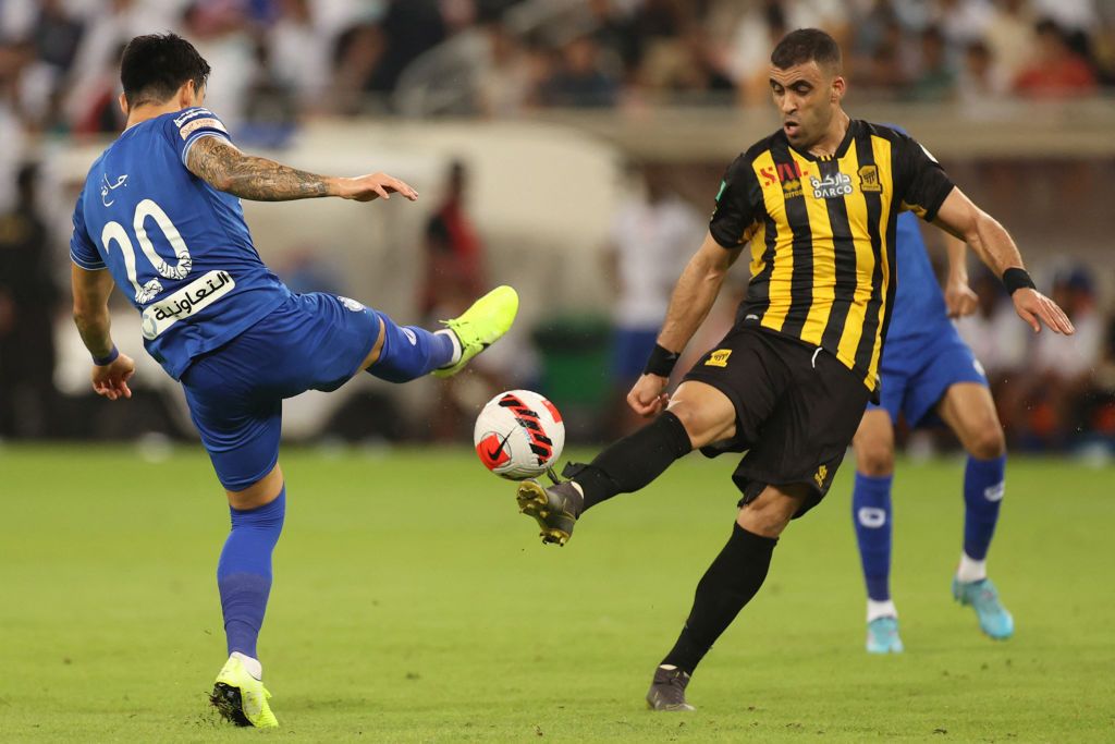 Ittihad's forward Abderrazak Hamdallah (R) is marked by Hilal's defender Jang Hyun-soo (L) during a Saudi Pro League football match between al-Ittihad and al-Hilal at the King Abdullah Sports City in Jeddah on May 23, 2022. (Photo by AFP) (Photo by -/AFP via Getty Images)