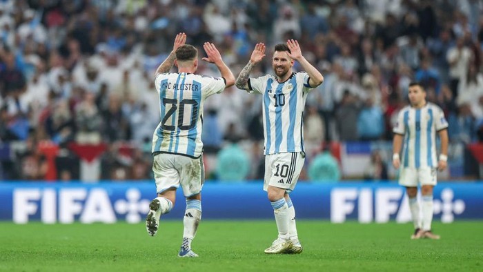 LUSAIL CITY, QATAR - DECEMBER 18: Lionel Messi of Argentina celebrates with Alexis Mac Allister after scoring the teams third goal during the FIFA World Cup Qatar 2022 Final match between Argentina and France at Lusail Stadium on December 18, 2022 in Lusail City, Qatar. (Photo by Maja Hitij - FIFA/FIFA via Getty Images)