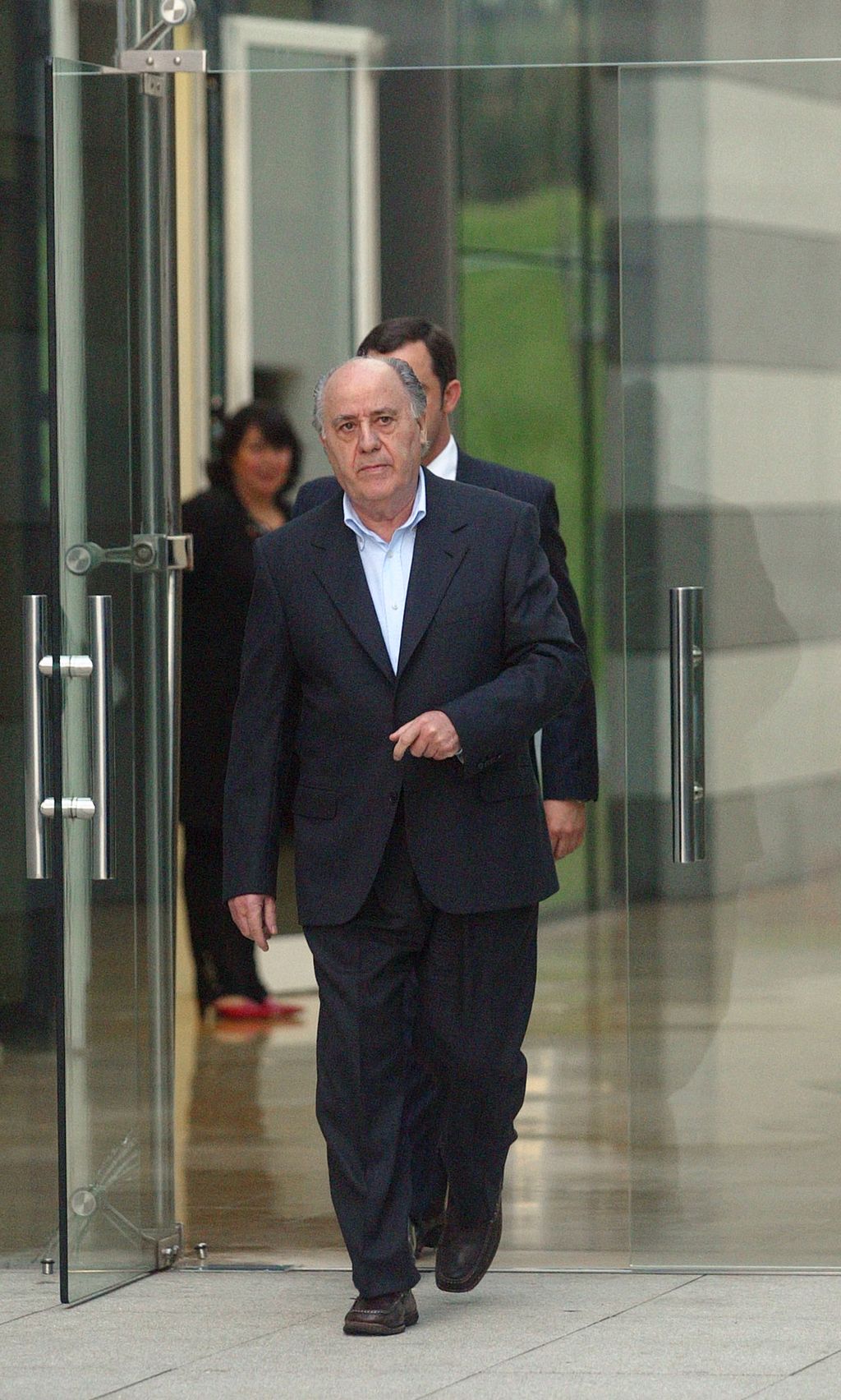 Amancio Ortega, general manager of Spanish textil company Zara, goes out to welcome Uruguayan President Jorge Batlle, in Arteixo, near Coruna, northwestern Spain, 04 February 2004. Jorge Batlle is in Spain for a one-week-long official visit. (Photo by MIGUEL RIOPA / AFP)