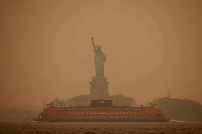 FILE PHOTO: The Statue of Liberty is covered in haze and smoke caused by wildfires in Canada, in New York, U.S., June 6, 2023. REUTERS/Amr Alfiky/File Photo