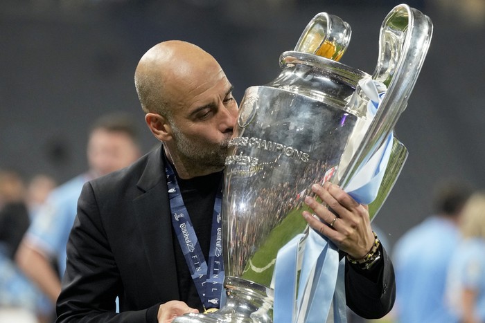Manchester Citys head coach Pep Guardiola kisses the trophy after winning the Champions League final soccer match between Manchester City and Inter Milan at the Ataturk Olympic Stadium in Istanbul, Turkey, Sunday, June 11, 2023. Manchester City won 1-0. (AP Photo/Francisco Seco)