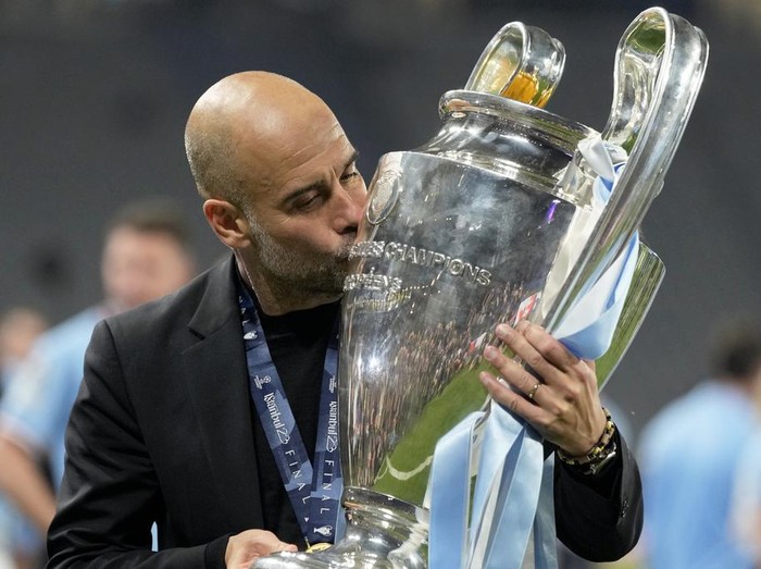 Manchester City's head coach Pep Guardiola kisses the trophy after winning the Champions League final soccer match between Manchester City and Inter Milan at the Ataturk Olympic Stadium in Istanbul, Turkey, Sunday, June 11, 2023. Manchester City won 1-0. (AP Photo/Francisco Seco)