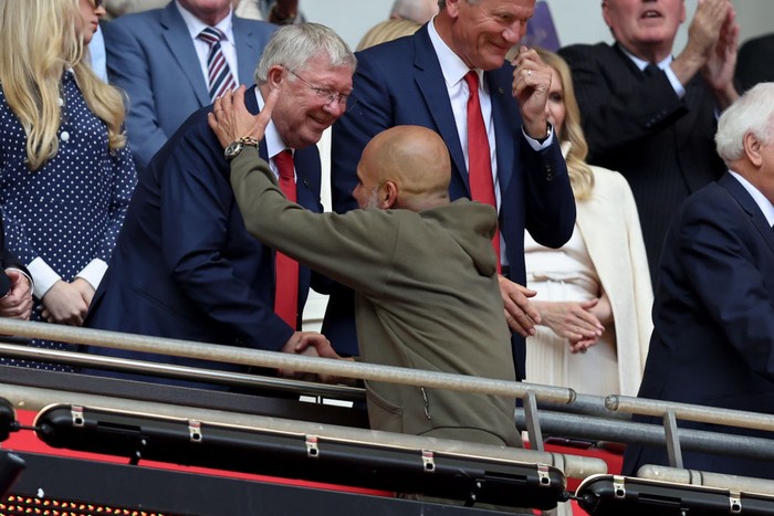 LONDON, ENGLAND - JUNE 3: Sir Alex Ferguson greets Pep Guardiola the head coach / manager of Manchester City during the Emirates FA Cup Final match between Manchester City and Manchester United at Wembley Stadium on June 03, 2023 in London, England. (Photo by James Williamson - AMA/Getty Images)