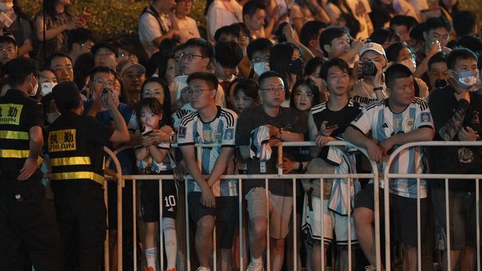 Chinese fans cheer as they catch a glimpse of superstar Lionel Messi, second from left, and other members of the Argentina national soccer team as they return to their hotel on a bus in Beijing, Monday, June 12, 2023. Argentina is scheduled to play Australia in a friendly match in China's capital on Thursday. (AP Photo/Ng Han Guan)