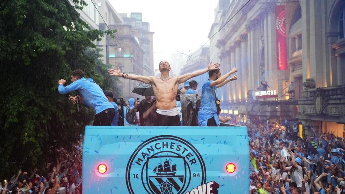 MANCHESTER, ENGLAND - JUNE 12: Jack Grealish of Manchester City celebrates on the Open-Top Bus during the Manchester City trophy parade on June 12, 2023 in Manchester, England. (Photo by Lexy Ilsley - Manchester City/Manchester City FC via Getty Images)