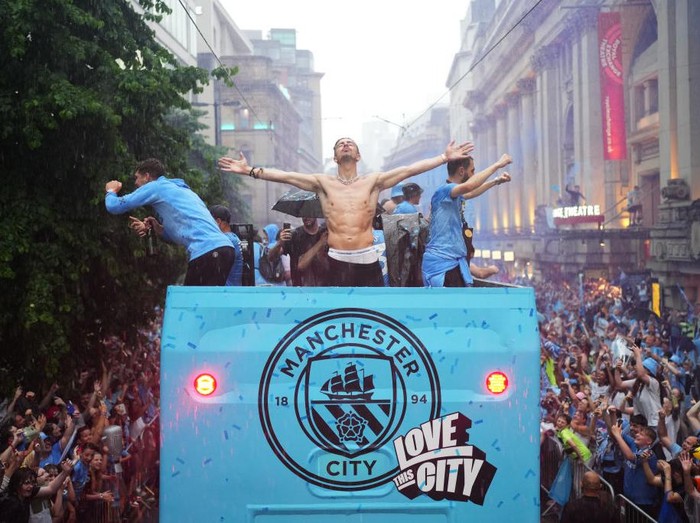MANCHESTER, ENGLAND - JUNE 12: Jack Grealish of Manchester City celebrates on the Open-Top Bus during the Manchester City trophy parade on June 12, 2023 in Manchester, England. (Photo by Lexy Ilsley - Manchester City/Manchester City FC via Getty Images)