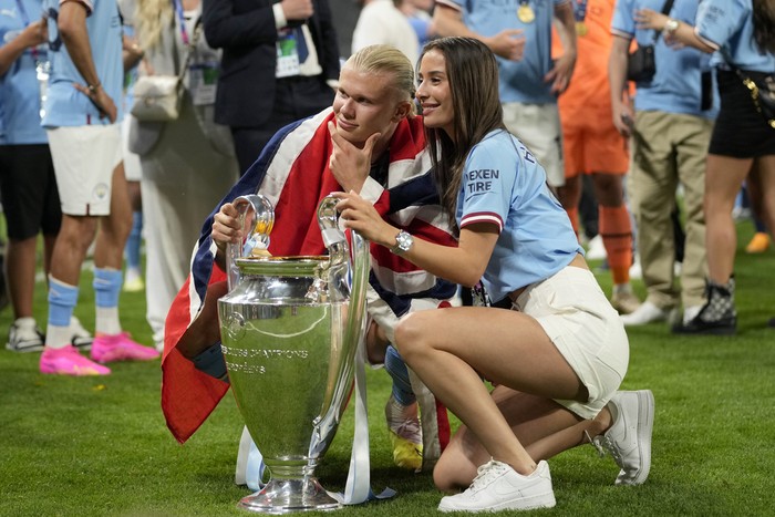 Manchester Citys Erling Haaland poses with the trophy after winning the Champions League final soccer match between Manchester City and Inter Milan at the Ataturk Olympic Stadium in Istanbul, Turkey, Sunday, June 11, 2023. Manchester City won 1-0. (AP Photo/Francisco Seco)