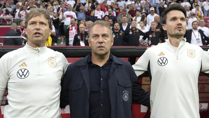 Germanys head coach Hans-Dieter Flick, centre, waits for the start of the international friendly soccer match between Poland and Germany at the Narodowy stadium in Warsaw, Poland, Friday, June 16, 2023. (AP Photo/Czarek Sokolowski)