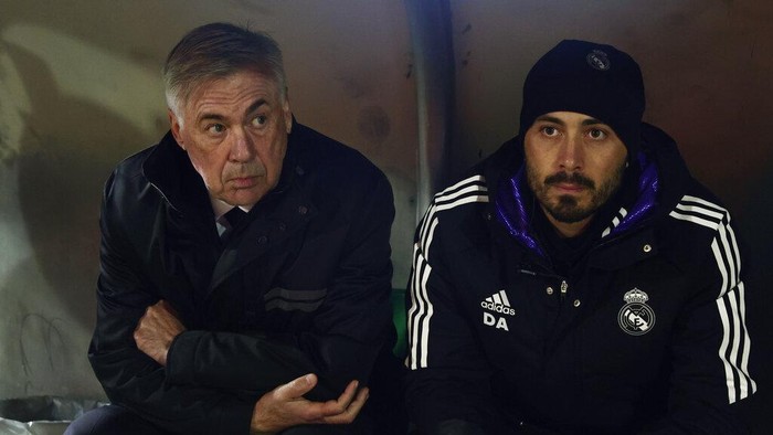 Carlo-Davide Ancelotti Real Madrids head coach Carlo Ancelotti, left sits next to his son and assistant coach Davide Ancelotti before the start of a Spanish Copa del Rey round of 32 soccer match between Cacereno and Real Madrid at the Principe Felipe stadium in Caceres, Spain, Tuesday Jan. 3, 2023. (AP Photo/Pablo Garcia)