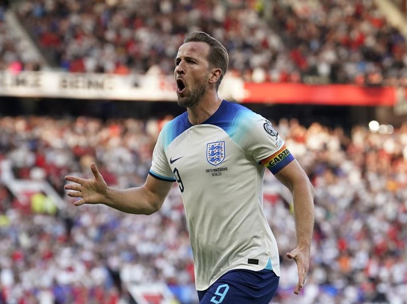 England's Harry Kane celebrates after scoring the opening goal during the Euro 2024 group C qualifying soccer match between England and North Macedonia at Old Trafford in Manchester, Monday June 19, 2023. (AP Photo/Dave Thompson)