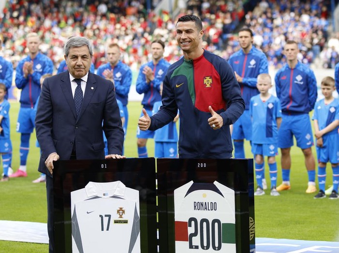 Portugal's Cristiano Ronaldo receives honors to mark his 200th international appearance before the Euro 2024 group J qualifying soccer match between Iceland and Portugal in Reykjavík, Iceland, Tuesday, June 20, 2023. (AP Photo/Brynjar Gunnarsson)