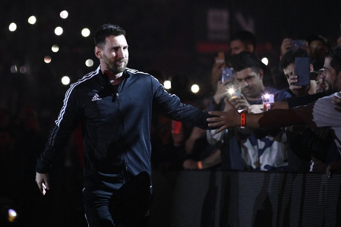Argentine football player Lionel Messi greets fans during his entrance to the field before the start of Maximiliano Rodriguezs farewell match at the Marcelo Bielsa stadium in Rosario, Argentina on January 24, 2023. (Photo by STRINGER / AFP)