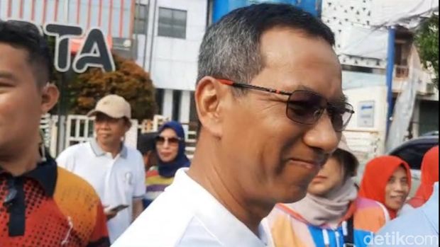 Pj Gubernur DKI Heru Budi Hartono tersenyum saat ditanya soal Ganjar telepon usai dengar keluhan warga. (Annisa/detikcom)