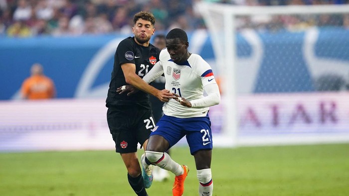 Jun 18, 2023; Las Vegas, Nevada, USA; USA forward Timothy Weah (21) battles for the ball against Canada midfielder Jonathan Osorio (21) during the first half at Allegiant Stadium. Mandatory Credit: Lucas Peltier-USA TODAY Sports