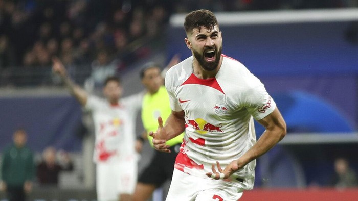 Leipzigs Josko Gvardiol celebrates after scoring his sides opening goal during the UEFA Champions League round of sixteen first leg soccer match between RB Leipzig and Manchester City in Leipzig, Germany, Wednesday, Feb. 22, 2023. (AP Photo/Andreas Gora)