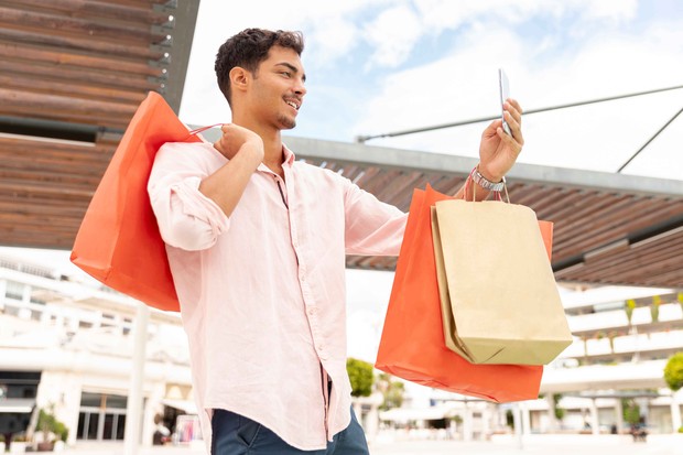 Ilustrasi pria memegang tas belanja/Foto: Freepik/freepik