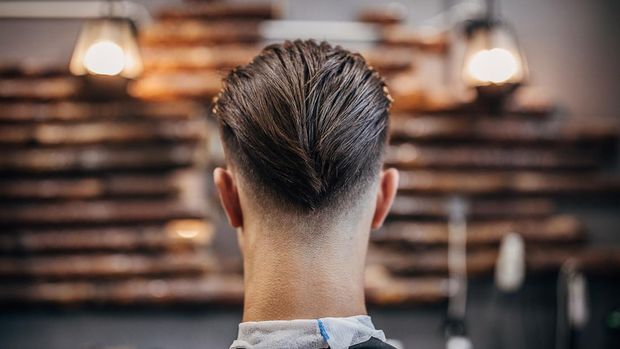 One man, handsome young man with modern haircut at the barber shop.