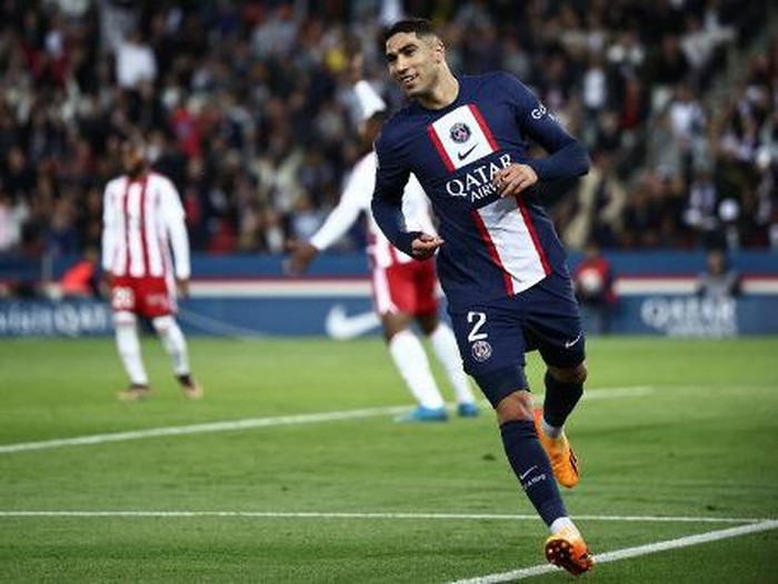 Paris Saint-Germain's Moroccan defender Achraf Hakimi celebrates after scoring a goal during the French L1 football match between Paris Saint-Germain (PSG) and Ajaccio at the Parc des Princes in Paris, on May 13, 2023. (Photo by Anne-Christine POUJOULAT / AFP)