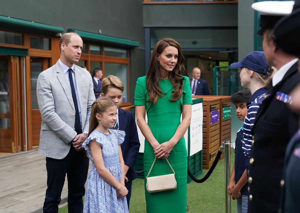 LONDON, ENGLAND - JULY 16: (L-R) Prince William, Prince of Wales, Princess Charlotte, Prince George and Catherine, Princess of Wales, speak to ball boys and girls as they arrive to attend day fourteen of the Wimbledon Tennis Championships at All England Lawn Tennis and Croquet Club on July 16, 2023 in London, England. (Photo by Victoria Jones - WPA Pool/Getty Images)