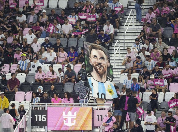 Jul 16, 2023; Ft. Lauderdale, FL, USA; Inter Miami CF fans hold up Lionel Messi signs and banners as he introduced at The Unveil event and press conference at DRV PNK Stadium. Mandatory Credit: Jasen Vinlove-USA TODAY Sports