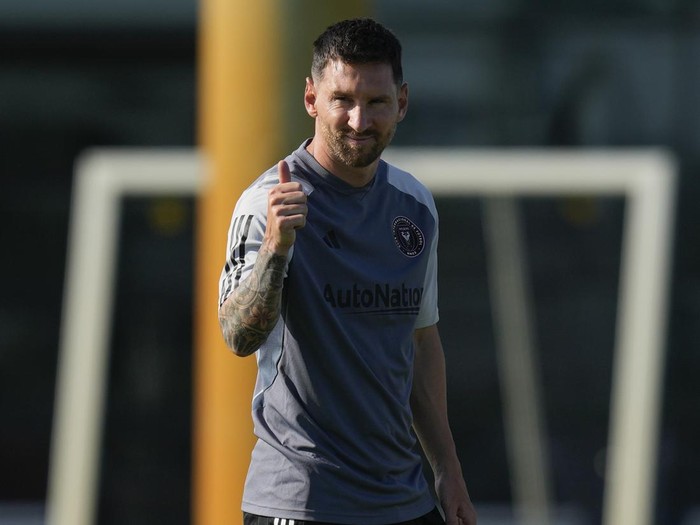 Lionel Messi gives a thumbs up toward journalists as he participates in a training session for the Inter Miami MLS soccer team Tuesday, July 18, 2023, in Fort Lauderdale, Fla.(AP Photo/Rebecca Blackwell)