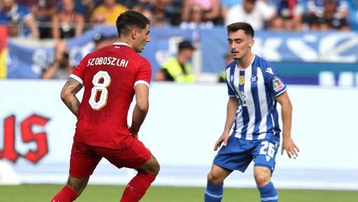 Liverpools Hungarian midfielder Dominik Szoboszlai (L) and Karlsruhes Paul Nebel vie for the ball during the pre-season friendly football match between Karlsruhe SC and Liverpool FC in Karlsruhe, western Germany, on July 19, 2023. (Photo by Daniel ROLAND / AFP)
