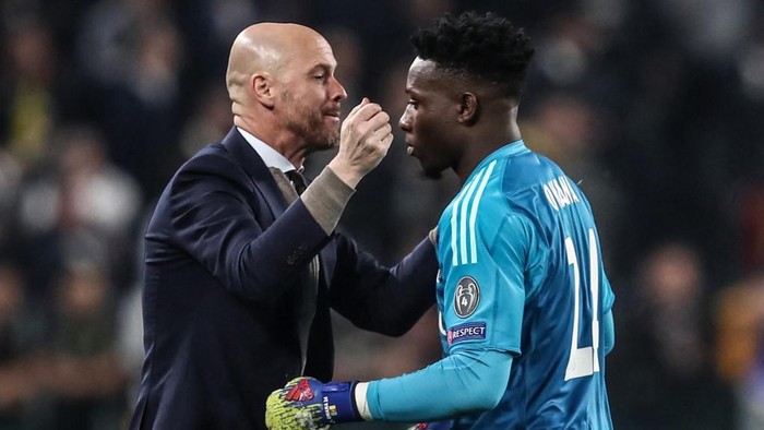 Ajaxs Dutch coach Erik Ten Hag (L) congratulates Ajaxs Cameroonian goalkeeper Andre Onana during the UEFA Champions League quarter-final second leg football match Juventus vs Ajax Amsterdam on April 16, 2019 at the Juventus stadium in Turin. (Photo by Isabella BONOTTO / AFP)