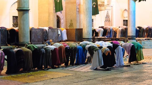 Sarajevo, Bosnia and Herzegovina - September 3, 2009: Segregated muslims bowing in Isha prayer at Gazi Husrev-beg mosque