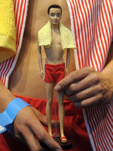 A model dressed in a Ken costume poses with Ken doll in the exhibition booth fo the US company Mattel at the press preview of the international toy fair in Nuremberg, southern Germany, on February 2, 2011. The Ken doll celebrates its 50th anniversary in 2011. Around 2.700 exhibitors from 60 countries shows their newest products at the international toy fair which opens its doors from February 3, until 8, 2011. AFP PHOTO / CHRISTOF STACHE (Photo by CHRISTOF STACHE / AFP)