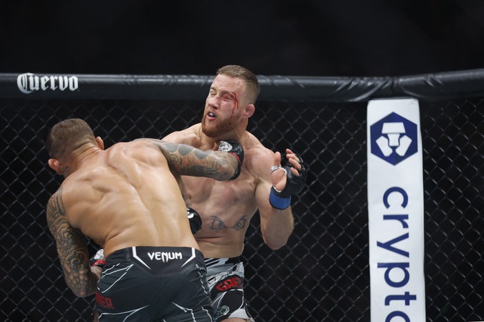 Jul 29, 2023; Salt Lake City, Utah, USA; Justin Gaethje (blue gloves) reacts to defeating Dustin Poirier (red gloves) during UFC 291 at Delta Center. Mandatory Credit: Jeff Swinger-USA TODAY Sports