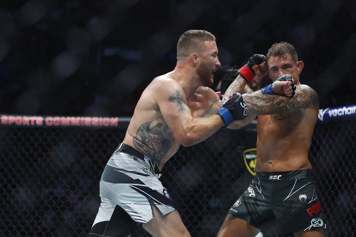 Jul 29, 2023; Salt Lake City, Utah, USA; Justin Gaethje (blue gloves) reacts to defeating Dustin Poirier (red gloves) during UFC 291 at Delta Center. Mandatory Credit: Jeff Swinger-USA TODAY Sports