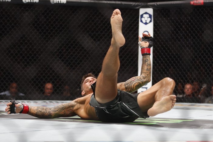 Jul 29, 2023; Salt Lake City, Utah, USA; Justin Gaethje (blue gloves) reacts to defeating Dustin Poirier (red gloves) during UFC 291 at Delta Center. Mandatory Credit: Jeff Swinger-USA TODAY Sports