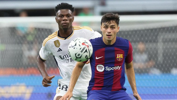 Jul 29, 2023; Arlington, Texas, USA;  Real Madrid midfielder Aurelien Tchouameni (18) and FC Barcelona midfielder Pedri (8) go for the ball during the first half at AT&T Stadium. Mandatory Credit: Kevin Jairaj-USA TODAY Sports