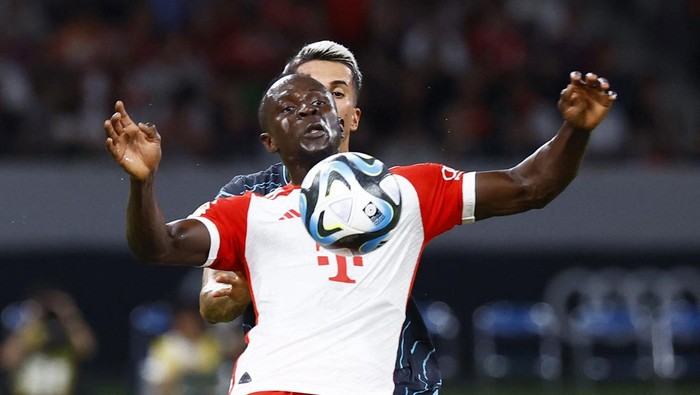 Soccer Football - Pre Season Friendly - Manchester City v Bayern Munich - Japan National Stadium, Tokyo, Japan - July 26, 2023 Bayern Munichs Sadio Mane in action with Manchester Citys Joao Cancelo REUTERS/Kim Kyung-Hoon