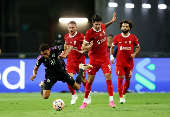 Soccer Football - Friendly - Liverpool v Bayern Munich - Singapore National Stadium, Singapore, Singapore - August 2, 2023 Bayern Munichs Jamal Musiala in action with Liverpools Dominik Szoboszlai REUTERS/Edgar Su