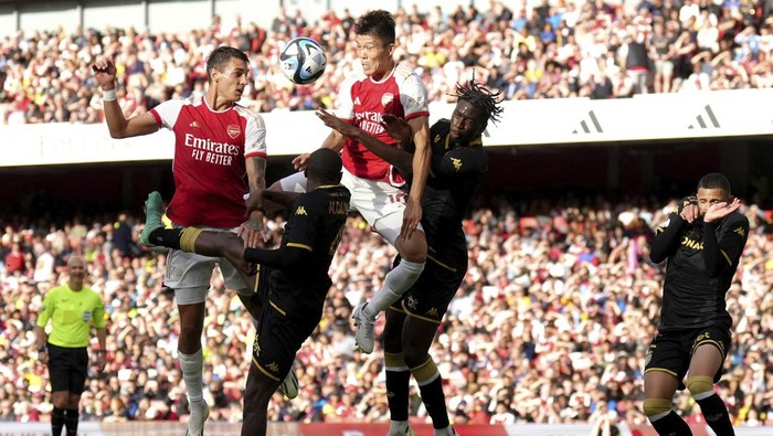 Arsenals Takehiro Tomiyasu, centre, heads the ball during the pre-season friendly match at the Emirates Stadium, London, Wednesday August 2, 2023. (John Walton/PA via AP)
