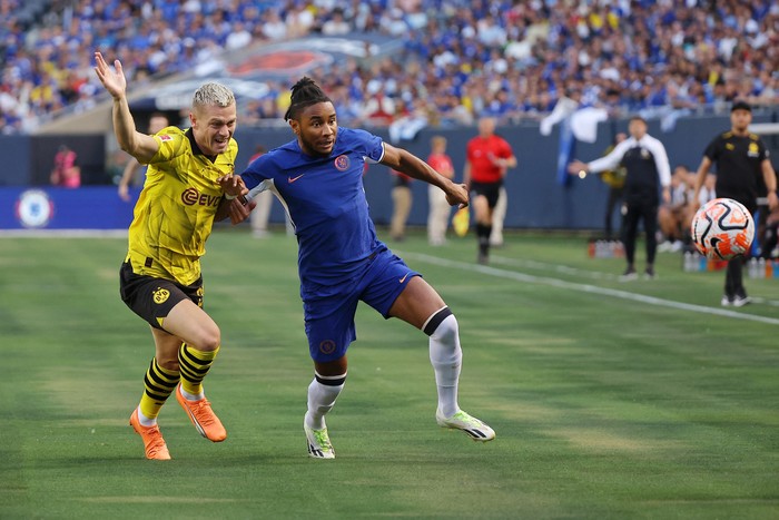 Aug 2, 2023; Chicago, Illinois, USA; Borussia Dortmund defender Julian Ryerson (26) battles for the ball against Chelsea forward Christopher Nkunku (45) during the first half at Soldier Field. Mandatory Credit: Jon Durr-USA TODAY Sports