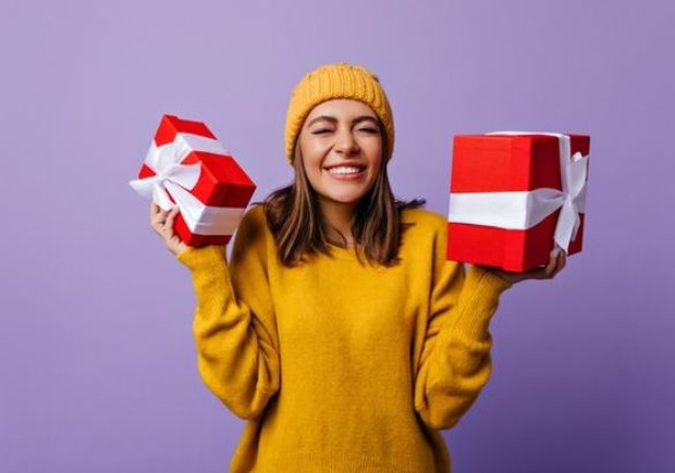 The woman is holding a gift in both hands