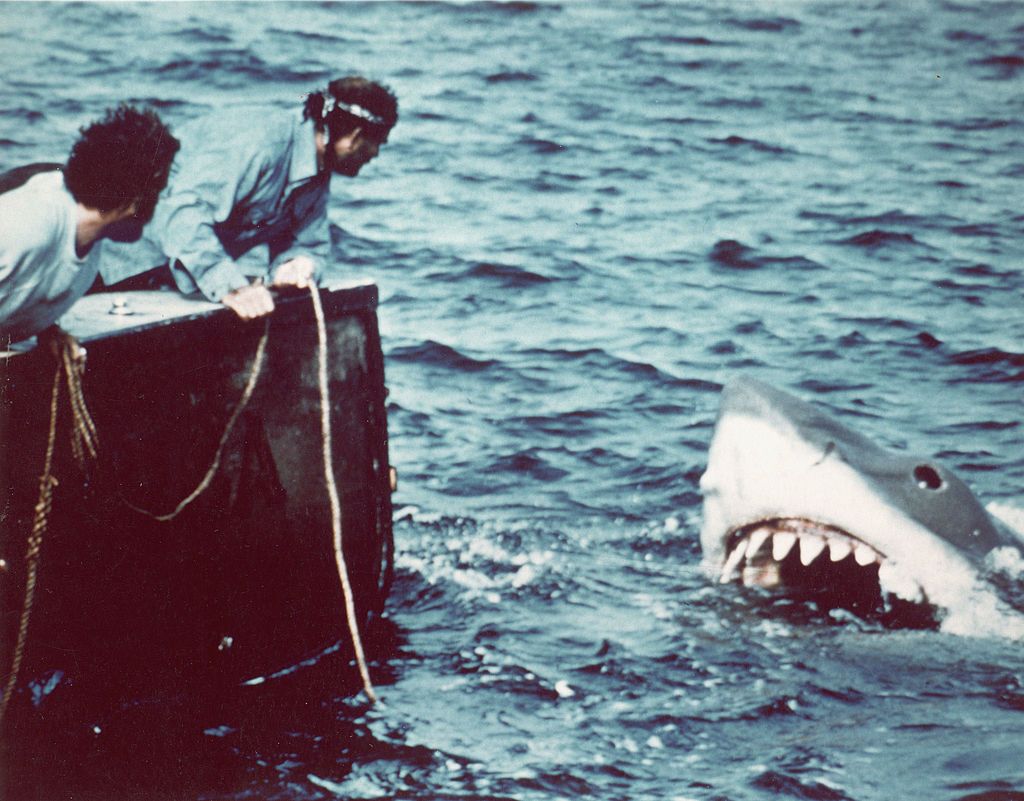 American actor Richard Dreyfuss (left) (as marine biologist Hooper) and British author and actor Robert Shaw (as shark fisherman Quint) look off the stern of Quint's fishing boat the 'Orca' at the terrifying approach of the mechanical giant shark dubbed 'Bruce' in a scene from the film 'Jaws' directed by Steven Spielberg, 1975. The movie, also starring Roy Scheider and Lorraine Gary, was one of the first 'Summer Blockbuster' films. (Photo by Universal Pictures courtesy of Getty Images)