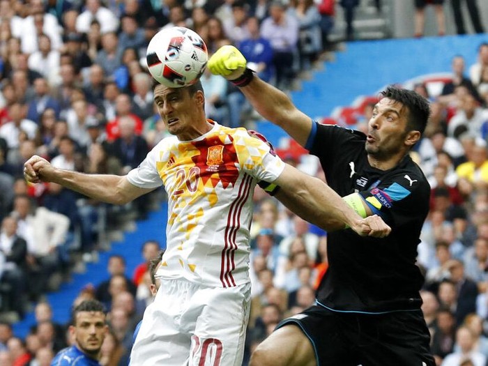 Italy goalkeeper Gianluigi Buffon clears the ball ahead of Spain's Aritz Aduriz during the Euro 2016 round of 16 soccer match between Italy and Spain, at the Stade de France, in Saint-Denis, north of Paris, Monday, June 27, 2016. (AP Photo/Antonio Calanni)